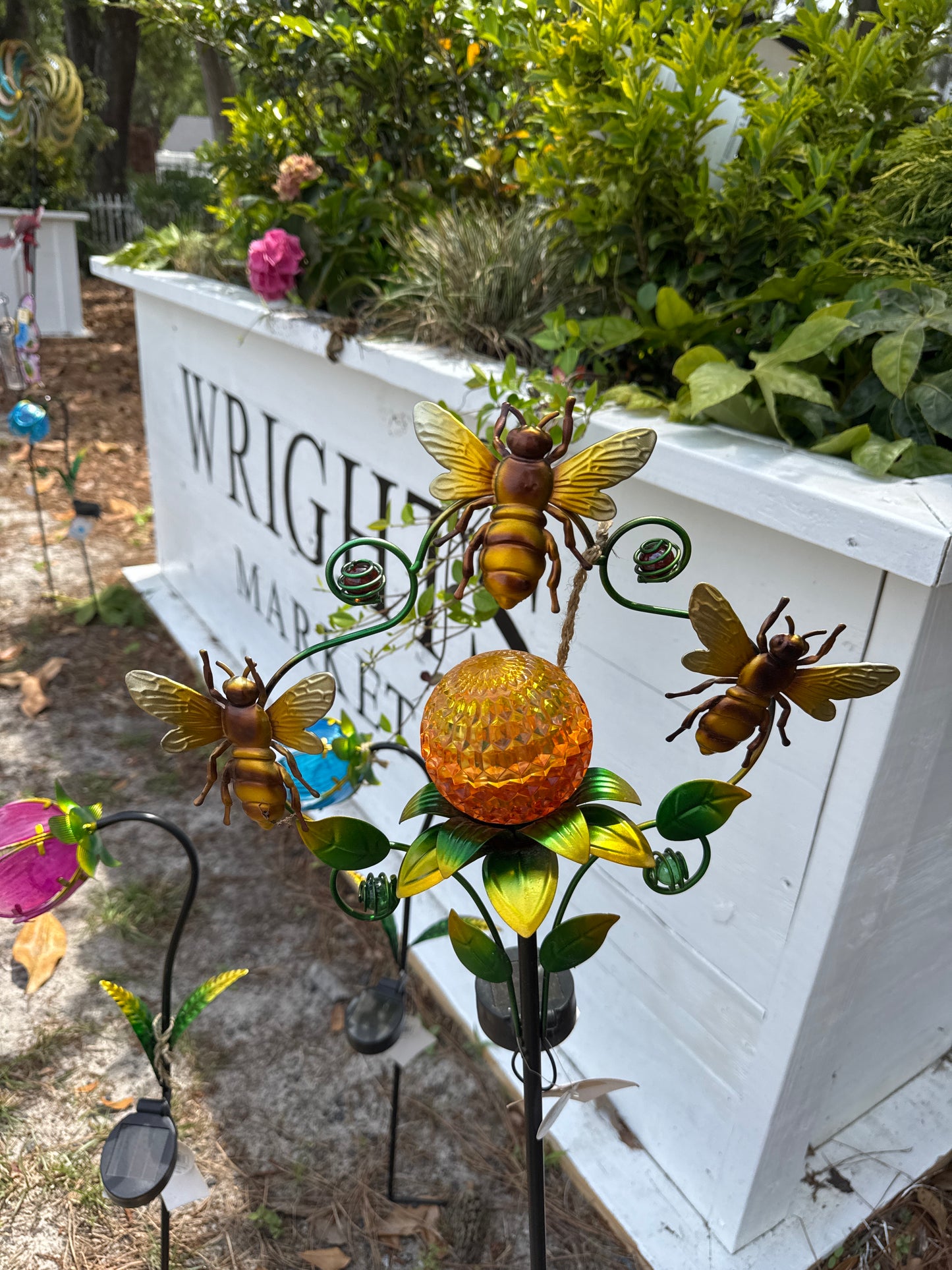 Metal bee with ball on a pole